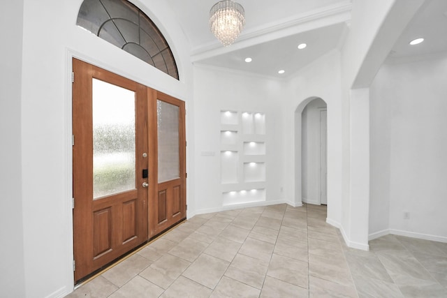 16015 Conners Ace Dr, Spring, TX 77379 - foyer entrance featuring arched walkways, light tile patterned flooring, a chandelier, recessed lighting, and crown molding