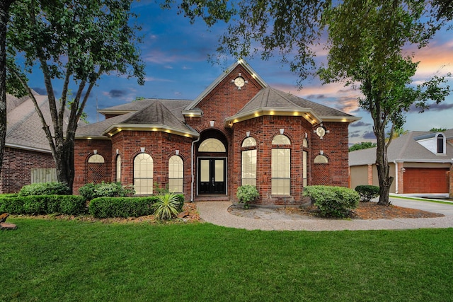 16015 Conners Ace Dr, Spring, TX 77379 - view of front of home featuring a lawn, brick siding, a garage, and a shingled roof