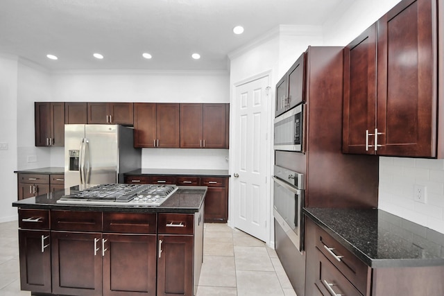 16015 Conners Ace Dr, Spring, TX 77379 - kitchen featuring appliances with stainless steel finishes, crown molding, backsplash, light tile patterned floors, and reddish brown cabinets
