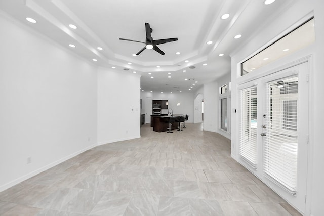 16015 Conners Ace Dr, Spring, TX 77379 - living room featuring a raised ceiling, arched walkways, recessed lighting, a ceiling fan, and a desk