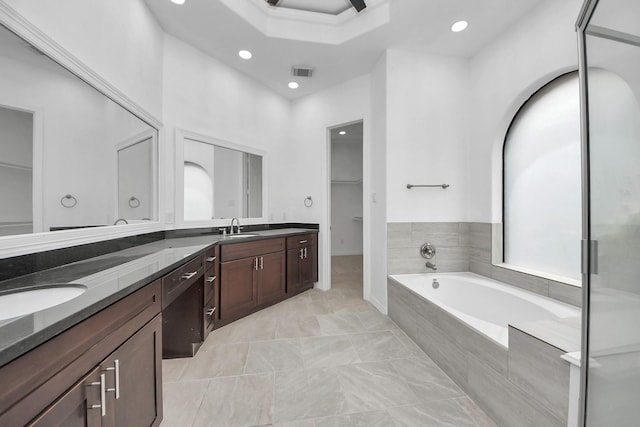 16015 Conners Ace Dr, Spring, TX 77379 - bathroom with double vanity, a garden tub, recessed lighting, a walk in closet, and a stall shower