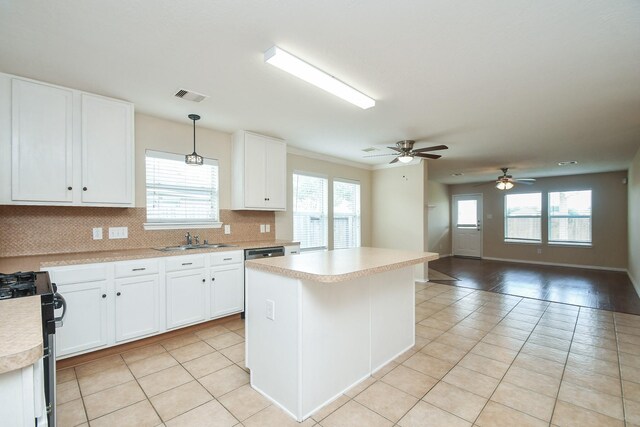 19826 Seagler Glen Ln, Katy, TX 77449 - kitchen with range with gas stovetop, light tile patterned flooring, light countertops, and healthy amount of natural light