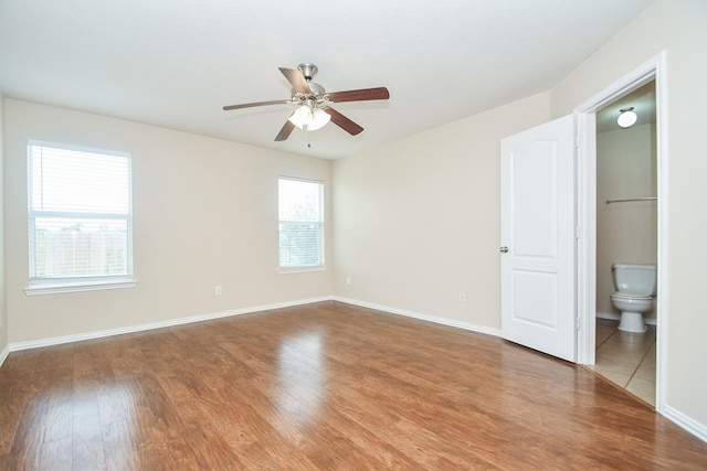 19826 Seagler Glen Ln, Katy, TX 77449 - unfurnished bedroom with wood finished floors, connected bathroom, and a ceiling fan