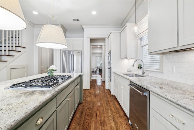 1017 Waverly St Unit B, Houston, TX 77008 - kitchen with stainless steel appliances, dark wood finished floors, decorative backsplash, light stone countertops, and decorative light fixtures