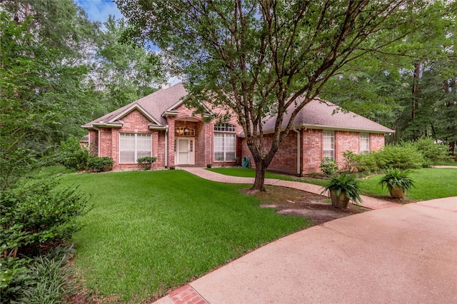 426 County Road 222, Nacogdoches, TX 75965 - view of front facade with brick siding, a front yard, and roof with shingles