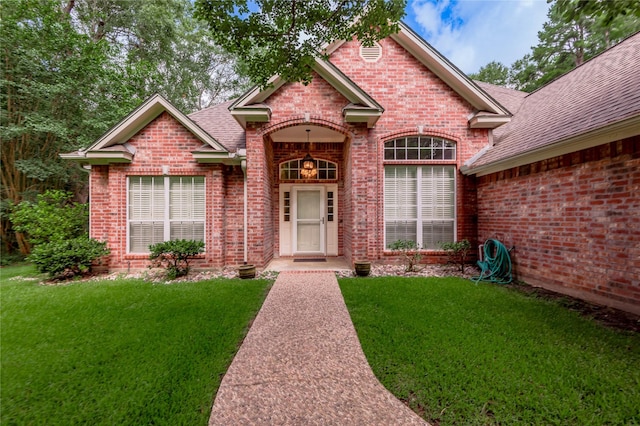 426 County Road 222, Nacogdoches, TX 75965 - view of front of property with brick siding, roof with shingles, and a front yard