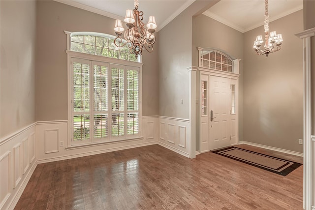 426 County Road 222, Nacogdoches, TX 75965 - entrance foyer featuring a chandelier, wood finished floors, a wainscoted wall, ornamental molding, and a decorative wall