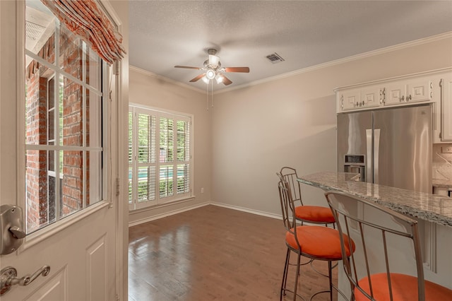 426 County Road 222, Nacogdoches, TX 75965 - dining room featuring ceiling fan, wood finished floors, crown molding, and a textured ceiling