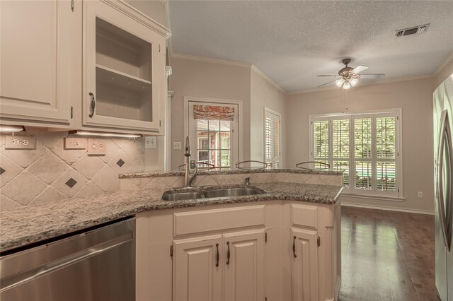 426 County Road 222, Nacogdoches, TX 75965 - kitchen featuring stainless steel dishwasher, a ceiling fan, a peninsula, tasteful backsplash, and a textured ceiling