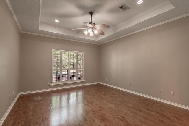 426 County Road 222, Nacogdoches, TX 75965 - spare room with a raised ceiling, a ceiling fan, dark wood-style flooring, and ornamental molding