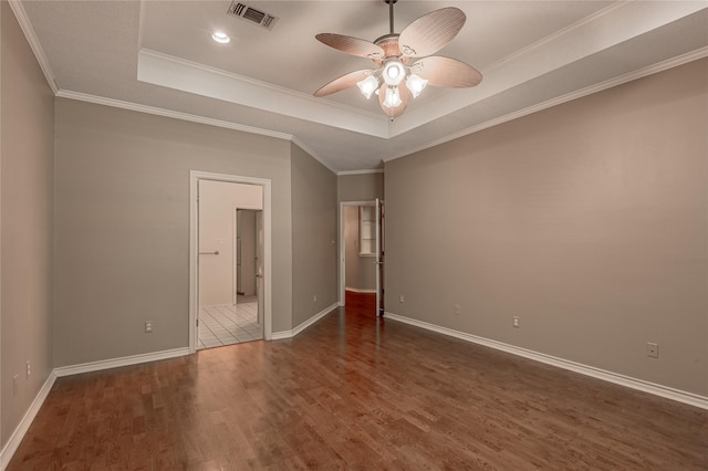 426 County Road 222, Nacogdoches, TX 75965 - spare room with dark wood finished floors, a tray ceiling, ceiling fan, ornamental molding, and recessed lighting