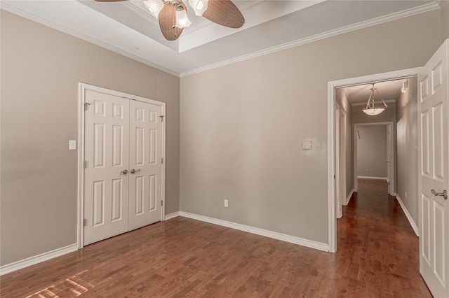 426 County Road 222, Nacogdoches, TX 75965 - unfurnished bedroom featuring wood finished floors, a closet, ornamental molding, ceiling fan, and a tray ceiling