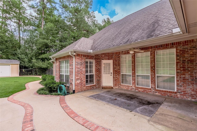 426 County Road 222, Nacogdoches, TX 75965 - view of exterior entry with a patio area, a shingled roof, and brick siding