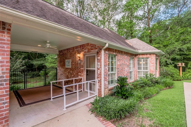 426 County Road 222, Nacogdoches, TX 75965 - property entrance with ceiling fan, brick siding, a shingled roof, and a patio