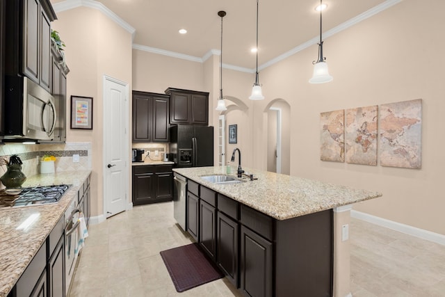 119 Reese Run St, Montgomery, TX 77316 - kitchen featuring stainless steel appliances, arched walkways, decorative backsplash, an island with sink, and ornamental molding