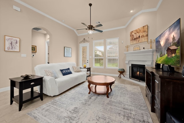 119 Reese Run St, Montgomery, TX 77316 - living room featuring ornamental molding, a glass covered fireplace, ceiling fan, light tile patterned floors, and arched walkways