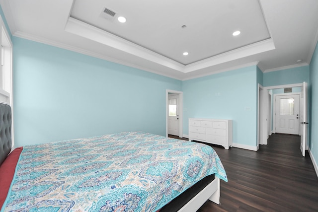 1309 24th St, Dickinson, TX 77539 - bedroom featuring a raised ceiling, dark wood-type flooring, recessed lighting, and ornamental molding