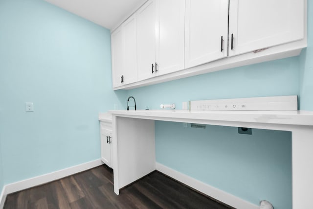1309 24th St, Dickinson, TX 77539 - laundry area with dark wood-type flooring and cabinet space