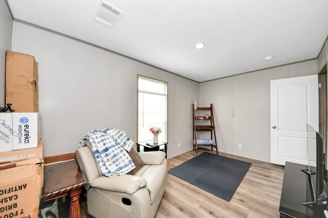 1309 24th St, Dickinson, TX 77539 - sitting room featuring light wood-style flooring and crown molding