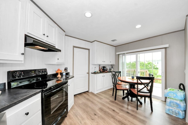 1309 24th St, Dickinson, TX 77539 - kitchen featuring electric range, under cabinet range hood, dark countertops, white cabinets, and crown molding