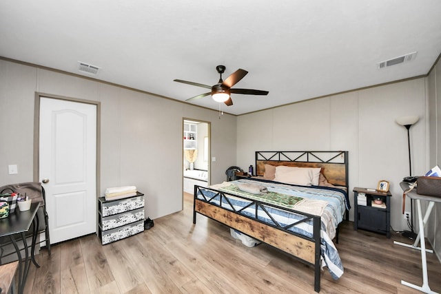 1309 24th St, Dickinson, TX 77539 - bedroom with ornamental molding, wood finished floors, ceiling fan, and a decorative wall