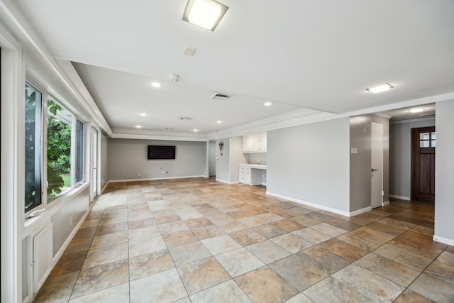 5659 Chevy Chase Dr, Houston, TX 77056 - unfurnished living room featuring healthy amount of natural light, light stone finish floors, ornamental molding, and recessed lighting