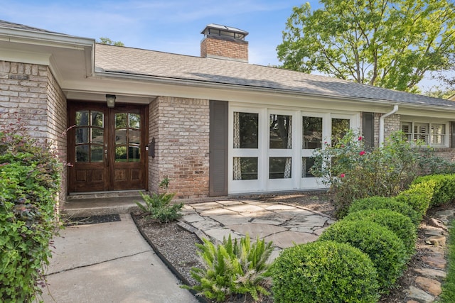 5659 Chevy Chase Dr, Houston, TX 77056 - doorway to property featuring french doors, brick siding, a chimney, and roof with shingles