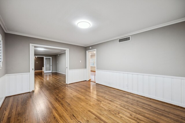 5659 Chevy Chase Dr, Houston, TX 77056 - spare room featuring a wainscoted wall, wood finished floors, and ornamental molding
