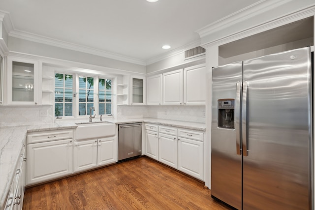 5659 Chevy Chase Dr, Houston, TX 77056 - kitchen with appliances with stainless steel finishes, open shelves, ornamental molding, white cabinetry, and light stone counters