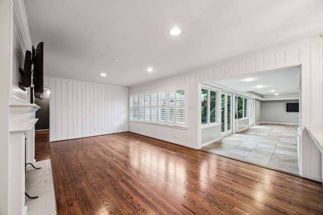5659 Chevy Chase Dr, Houston, TX 77056 - unfurnished living room with crown molding, wood finished floors, a fireplace, a decorative wall, and recessed lighting