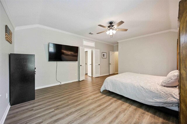 20315 Maple Village Dr, Cypress, TX 77433 - bedroom with wood finished floors, ornamental molding, and ceiling fan