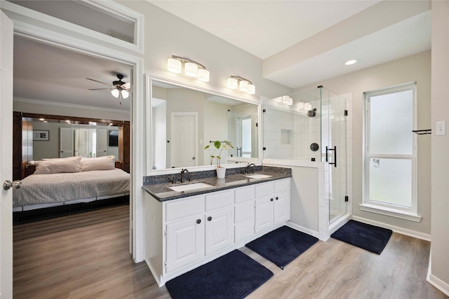 20315 Maple Village Dr, Cypress, TX 77433 - ensuite bathroom with double vanity, a shower stall, wood finished floors, ceiling fan, and ornamental molding