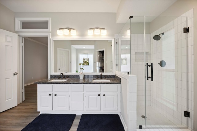 20315 Maple Village Dr, Cypress, TX 77433 - bathroom with a stall shower, double vanity, and wood finished floors