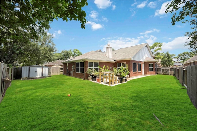 20315 Maple Village Dr, Cypress, TX 77433 - back of house featuring a fenced backyard, a storage unit, a garden, brick siding, and a chimney