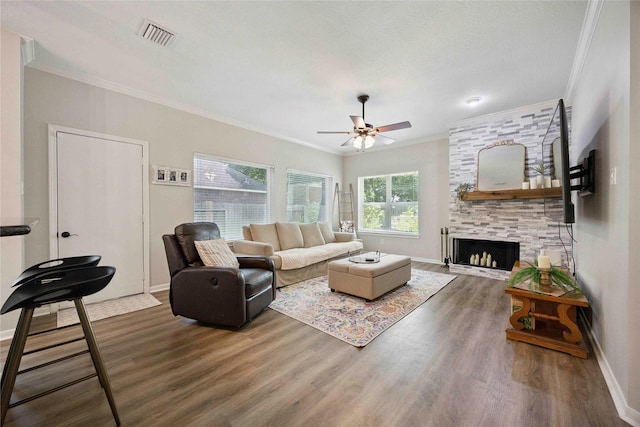 20315 Maple Village Dr, Cypress, TX 77433 - living room featuring ornamental molding, ceiling fan, wood finished floors, and a fireplace