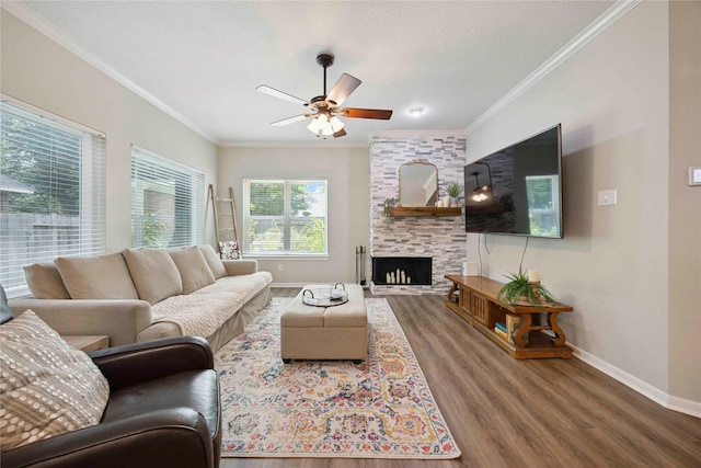 20315 Maple Village Dr, Cypress, TX 77433 - living area featuring crown molding, wood finished floors, a ceiling fan, and a large fireplace
