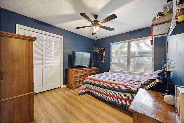 20315 Maple Village Dr, Cypress, TX 77433 - bedroom with light wood-style flooring, a closet, ceiling fan, and a textured ceiling