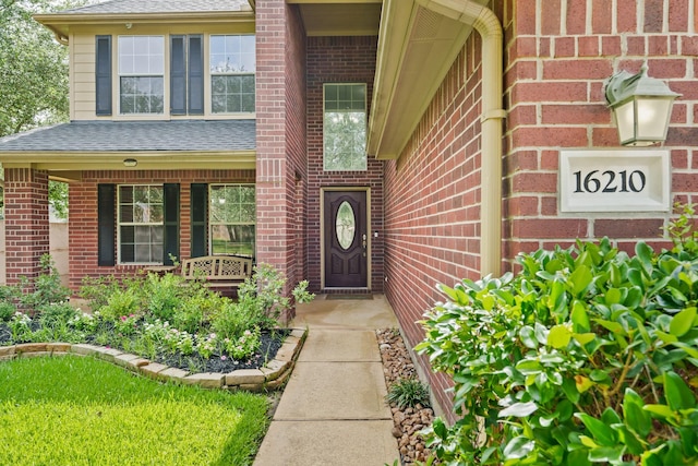 16210 Bloom Meadow Trl, Cypress, TX 77433 - entrance to property with a shingled roof, brick siding, and covered porch