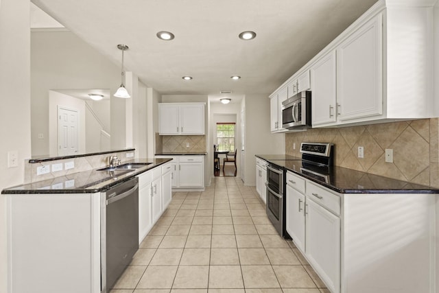 16210 Bloom Meadow Trl, Cypress, TX 77433 - kitchen featuring stainless steel appliances, tasteful backsplash, light tile patterned floors, white cabinetry, and recessed lighting
