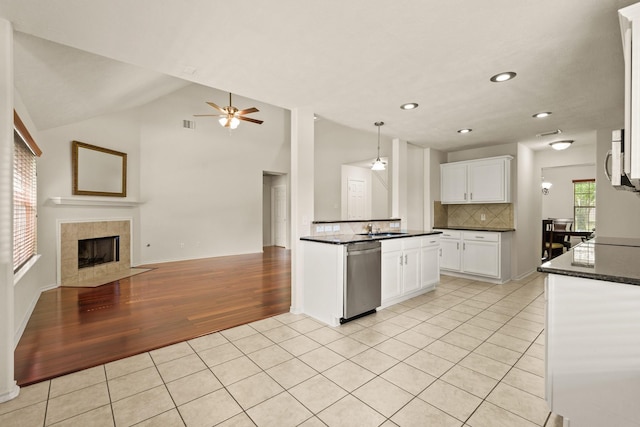 16210 Bloom Meadow Trl, Cypress, TX 77433 - kitchen with appliances with stainless steel finishes, open floor plan, light tile patterned flooring, ceiling fan, and decorative backsplash