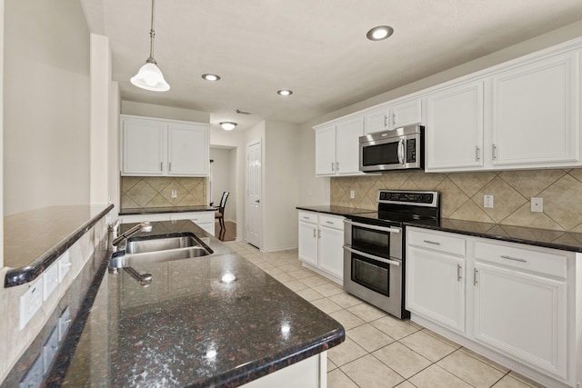 16210 Bloom Meadow Trl, Cypress, TX 77433 - kitchen with stainless steel appliances, tasteful backsplash, white cabinetry, recessed lighting, and light tile patterned floors
