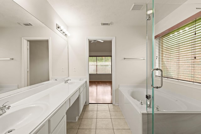 16210 Bloom Meadow Trl, Cypress, TX 77433 - full bathroom with a bath, double vanity, tile patterned floors, and a stall shower