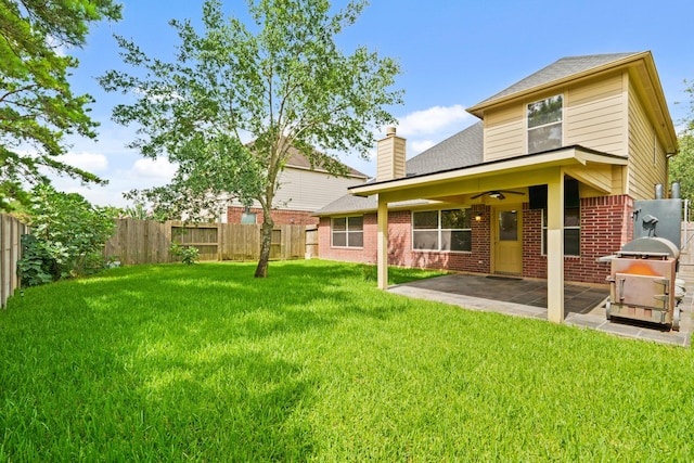 16210 Bloom Meadow Trl, Cypress, TX 77433 - rear view of house with a fenced backyard, a ceiling fan, a patio, and brick siding