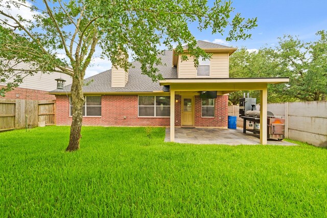 16210 Bloom Meadow Trl, Cypress, TX 77433 - back of house with brick siding, a patio, and a fenced backyard
