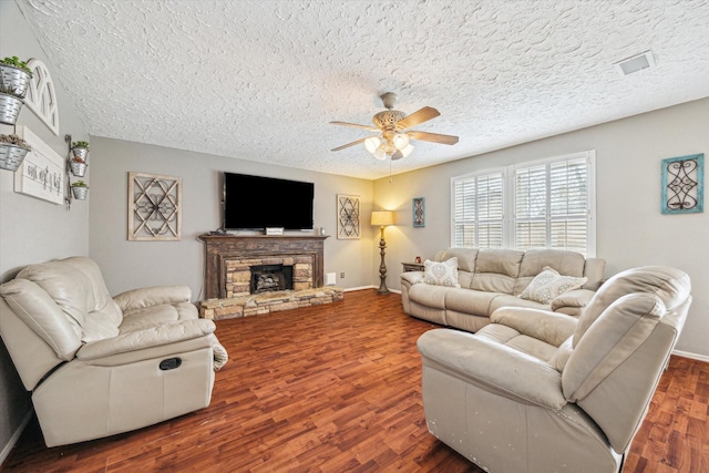2310 Parkview Dr, Pearland, TX 77581 - living area featuring a textured ceiling, ceiling fan, wood finished floors, and a fireplace
