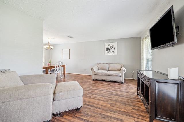 2310 Parkview Dr, Pearland, TX 77581 - living area featuring a chandelier, dark wood-style flooring, and a textured ceiling