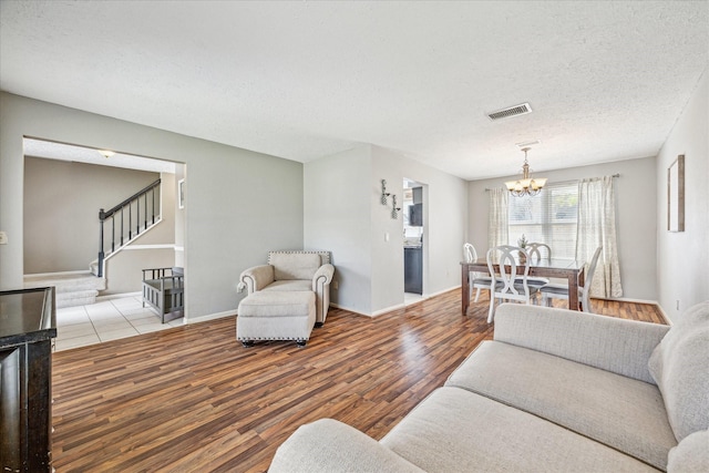 2310 Parkview Dr, Pearland, TX 77581 - living area with a chandelier, stairs, wood finished floors, and a textured ceiling