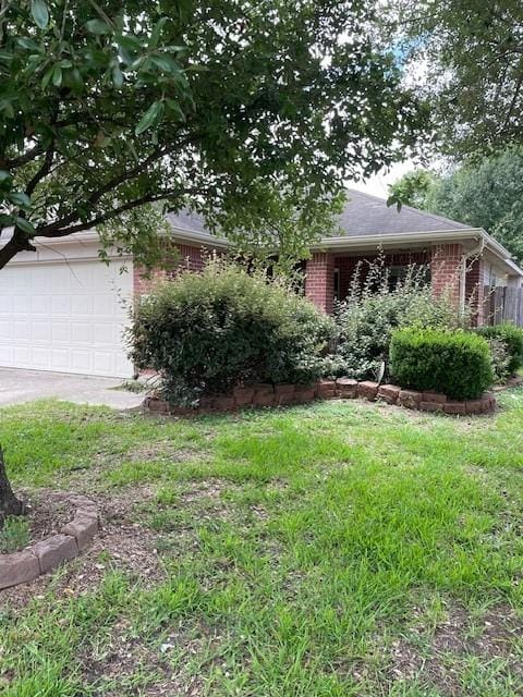 12326 Garden Gale Ln, Houston, TX 77044 - obstructed view of property featuring brick siding, a garage, and driveway