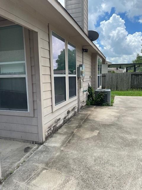 12326 Garden Gale Ln, Houston, TX 77044 - view of home's exterior featuring a patio and a chimney