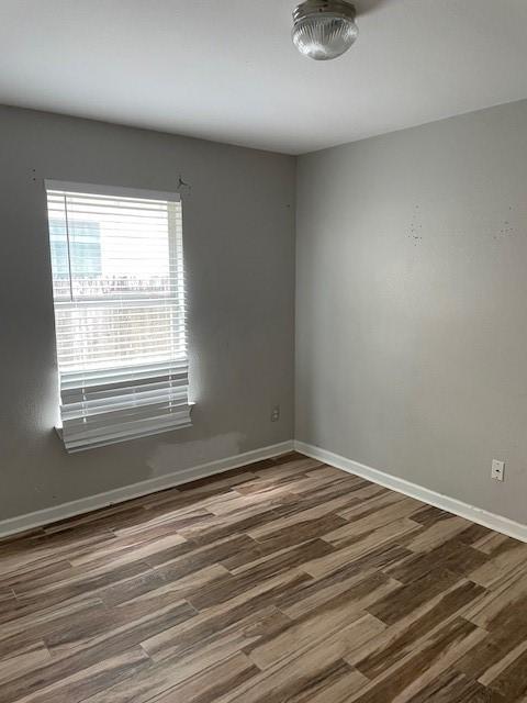 12326 Garden Gale Ln, Houston, TX 77044 - spare room featuring wood finished floors and baseboards